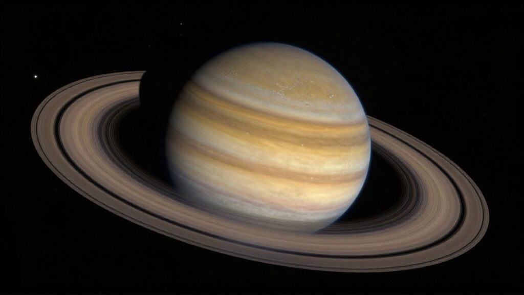 Saturno con sus anillos brillantes de hielo y roca flotando en la oscuridad del espacio.
